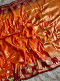 A fiery orange luxurious silk saree of burgundy shade boarder and golden zari of large floral panels with blouse