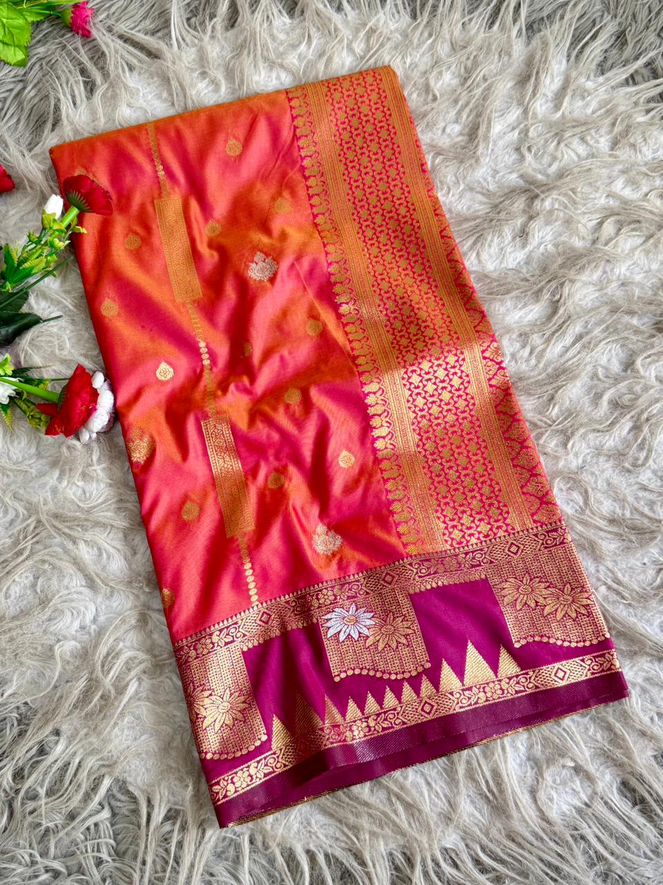 Coral orange premium soft silk saree of berry magenta triangular temple style motifs beneath the floral panels with blouse