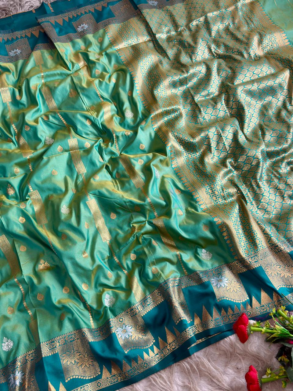 A refreshing aqua mint green premium soft silk saree  with a contrasting peacock tale boarder of large floral panels with blouse