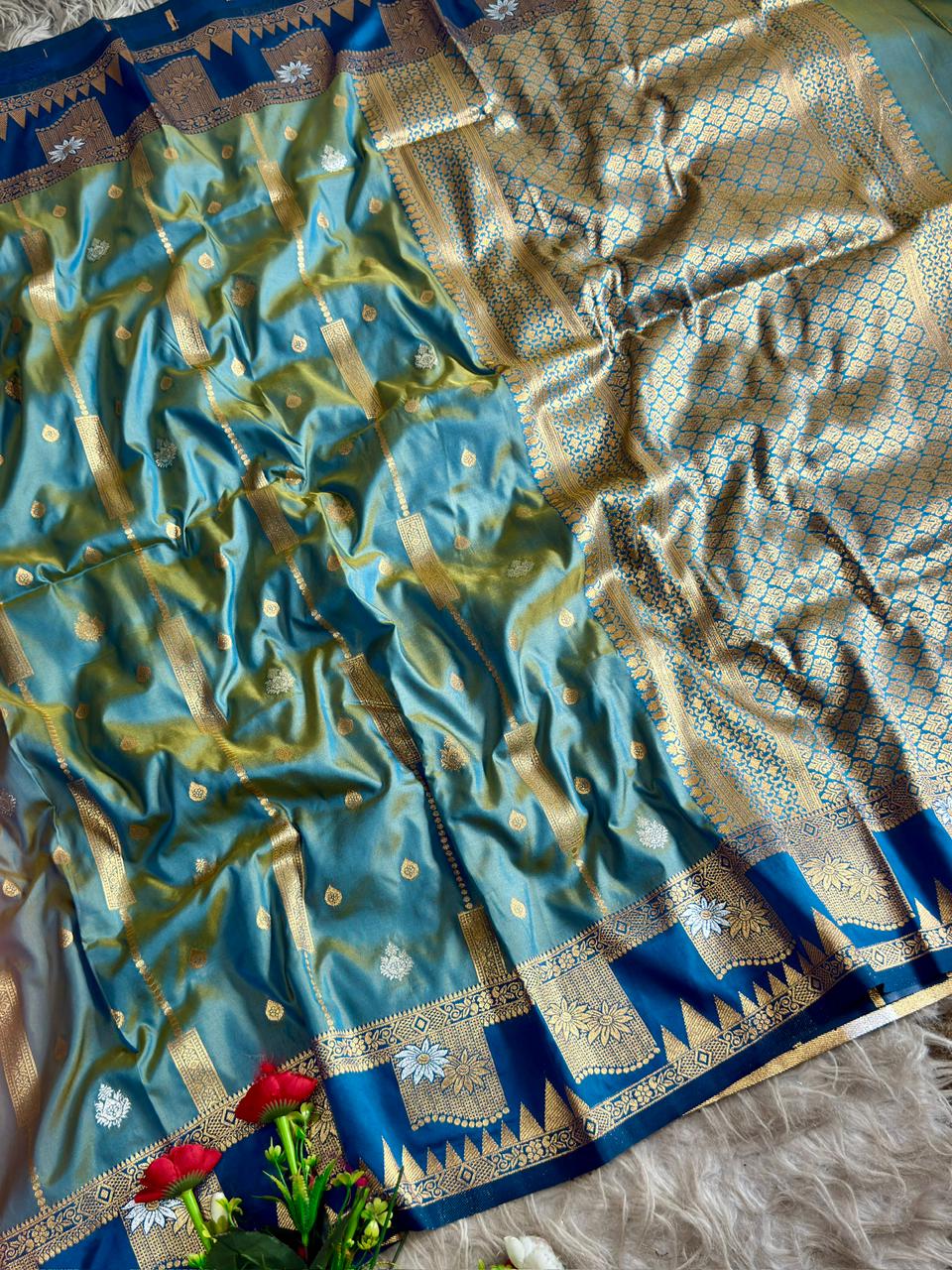 A beautiful peacock green silk saree with tale blue boarder of temple style motifs   with blouse