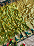 A beautiful olive green soft silk saree and a striking boarder of deep peacock tale temple style motifs with blouse