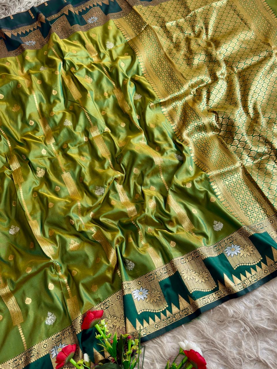 A beautiful olive green soft silk saree and a striking boarder of deep peacock tale temple style motifs with blouse