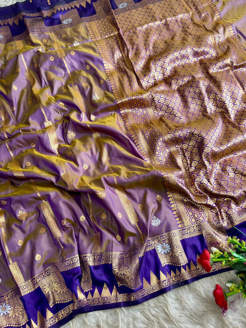 A gorgeous lavender purple soft silk saree of striking deep royal violet boarder and triangular temple style motifs Of gold and silver florals with blouse