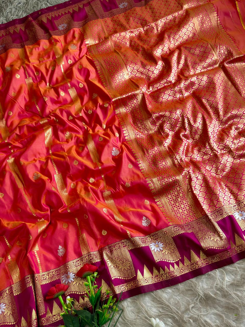 Coral orange premium soft silk saree of berry magenta triangular temple style motifs beneath the floral panels with blouse